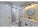 Modern bathroom boasts a sleek vanity, walk-in shower, and contemporary lighting fixtures at 1407 Noble Pl, Orlando, FL 32801