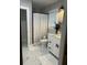 Bright bathroom with a shower, decorative white shower curtain, and white vanity with a faux marble countertop at 1407 Noble Pl, Orlando, FL 32801