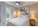 Bright bedroom featuring a ceiling fan and a large window for ample natural light at 1407 Noble Pl, Orlando, FL 32801