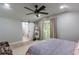 Calm bedroom with a ceiling fan and sliding door access to an outdoor deck at 1407 Noble Pl, Orlando, FL 32801