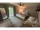 Inviting bedroom with neutral tones, plush bedding, and sliding glass doors leading to an outdoor patio at 1407 Noble Pl, Orlando, FL 32801