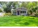 Charming single-story home featuring a well-manicured lawn, beautiful landscaping and a welcoming entryway at 1407 Noble Pl, Orlando, FL 32801