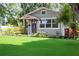 Inviting home with neat landscaping, healthy green yard, cozy porch, and freshly painted exterior at 1407 Noble Pl, Orlando, FL 32801