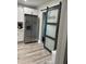The kitchen showcases stainless steel appliances and a frosted glass laundry door at 1407 Noble Pl, Orlando, FL 32801