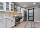 A modern kitchen with updated appliances, and a sliding barn door for added privacy at 1407 Noble Pl, Orlando, FL 32801