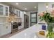Modern eat-in kitchen with stainless steel appliances, marble countertops, and sliding barn door access at 1407 Noble Pl, Orlando, FL 32801