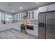 Spacious updated kitchen with stainless steel appliances, bright cabinetry, and luxury vinyl plank flooring at 1407 Noble Pl, Orlando, FL 32801