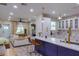 Bright, open-concept kitchen with white cabinets, marble countertops, and a large island with seating at 1407 Noble Pl, Orlando, FL 32801