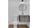 Modern bath with floating vanity and sleek round mirror at 1521 Nieuport Ln, Orlando, FL 32805