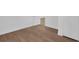Bright bedroom with wood-look flooring, white trim, and a neutral color palette that offers a modern aesthetic at 1521 Nieuport Ln, Orlando, FL 32805