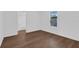 This bedroom has hardwood floors and a large window at 1521 Nieuport Ln, Orlando, FL 32805