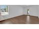 This room features a neutral color palette, with light hardwood floors and a large window for natural light at 1521 Nieuport Ln, Orlando, FL 32805