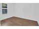 Bright bedroom with a large window and stylish wood-look flooring that creates a clean modern look at 1521 Nieuport Ln, Orlando, FL 32805
