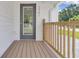 Inviting front porch with wooden decking and railings leading to the front door at 1521 Nieuport Ln, Orlando, FL 32805