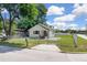 Cozy fenced home featuring a minimalist design, a mailbox, and a well-maintained lawn at 1521 Nieuport Ln, Orlando, FL 32805