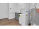 Well-lit laundry area with new washer and dryer units and cabinet for storage space at 1521 Nieuport Ln, Orlando, FL 32805