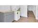 Bright laundry area with stackable washer/dryer and gray cabinets, enhanced by light wood-look flooring at 1521 Nieuport Ln, Orlando, FL 32805
