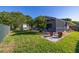 Expansive backyard featuring a screened pool area, a storage shed and grassy lawn at 1543 Reade Cir, St Cloud, FL 34772