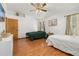 Bright bedroom with hardwood floors, two windows, ceiling fan and an ensuite bathroom at 1543 Reade Cir, St Cloud, FL 34772