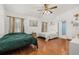 Comfortable bedroom with hardwood floors, two windows, ceiling fan and access to an ensuite bathroom at 1543 Reade Cir, St Cloud, FL 34772