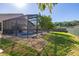 View of the screened pool area and rock landscaping in the yard at 1543 Reade Cir, St Cloud, FL 34772