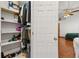 Organized walk-in closet with shelving for ample storage and a view into the bedroom at 1543 Reade Cir, St Cloud, FL 34772