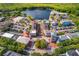 Aerial shot of a charming town center with a lake, surrounded by lush greenery and quaint buildings at 204 Celebration Blvd, Celebration, FL 34747