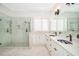 This bathroom features double sinks and a luxurious walk-in shower with beautiful marble tile at 204 Celebration Blvd, Celebration, FL 34747