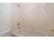 Bathroom featuring a tiled bathtub with shower and basic fixtures at 204 Celebration Blvd, Celebration, FL 34747