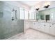This large bathroom features double sinks and a luxurious walk-in shower with marble tile at 204 Celebration Blvd, Celebration, FL 34747