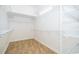 Walk-in closet with white wire shelving, and neutral vinyl flooring at 204 Celebration Blvd, Celebration, FL 34747