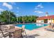 Gorgeous community pool with lounge chairs and tables, perfect for relaxing and enjoying the outdoors at 204 Celebration Blvd, Celebration, FL 34747