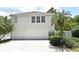Inviting two-story home with a three-car garage, surrounded by lush, mature landscaping at 204 Celebration Blvd, Celebration, FL 34747