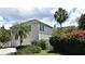 Charming two-story home with a well-maintained lawn and vibrant bougainvillea bushes at 204 Celebration Blvd, Celebration, FL 34747