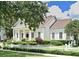 Classic white home with a welcoming front porch, manicured lawn, and charming picket fence at 204 Celebration Blvd, Celebration, FL 34747