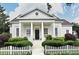 Charming home featuring a classic white picket fence, complemented by lush greenery and a welcoming front porch at 204 Celebration Blvd, Celebration, FL 34747