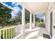 Spacious front porch with classic columns and railing, offering a pleasant outdoor living space at 204 Celebration Blvd, Celebration, FL 34747