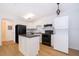 Bright kitchen with island, black appliances, white cabinets, and in-unit laundry at 204 Celebration Blvd, Celebration, FL 34747