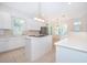 Bright kitchen with stainless steel appliances, tile backsplash, and center island cooktop at 204 Celebration Blvd, Celebration, FL 34747