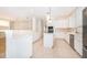 Spacious, open kitchen with white cabinets, stainless appliances, island, and views to the living areas at 204 Celebration Blvd, Celebration, FL 34747