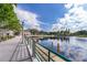 Scenic lakeside view from a wooden dock, showcasing serene water and lush surrounding landscape at 204 Celebration Blvd, Celebration, FL 34747
