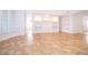 Bright living room with built-in shelving and cabinets, flowing to other rooms via archways at 204 Celebration Blvd, Celebration, FL 34747