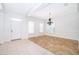 Bright living room features tile and hardwood flooring, neutral walls, and a modern chandelier at 204 Celebration Blvd, Celebration, FL 34747