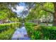 Scenic view of a waterway with lush landscaping and charming buildings in a walkable neighborhood at 204 Celebration Blvd, Celebration, FL 34747