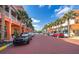 Picturesque street with colorful buildings, palm trees, and parked cars creating a vibrant atmosphere at 204 Celebration Blvd, Celebration, FL 34747