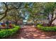 Beautiful brick town square with shade trees, benches, manicured flower beds, and a water fountain at 204 Celebration Blvd, Celebration, FL 34747