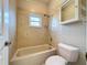Bathroom featuring a shower and bathtub combination with a small window and wall cabinet at 2150 Emperor Dr., Kissimmee, FL 34744