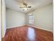 Bedroom with hardwood floors, ceiling fan, and a window that provides natural light at 2150 Emperor Dr., Kissimmee, FL 34744