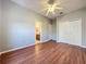 Bedroom featuring laminate wood floor, neutral wall paint, and view of the bathroom at 2150 Emperor Dr., Kissimmee, FL 34744
