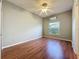 Bedroom featuring laminate wood floor, neutral wall paint, and a bright window at 2150 Emperor Dr., Kissimmee, FL 34744